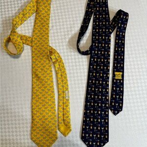 Hermes ties 100% silk. One yellow the other navy blue.